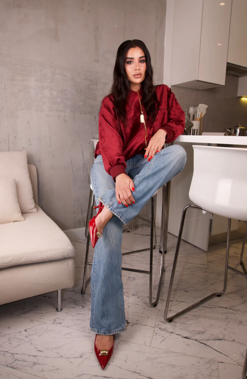 Burgundy crushed velvet bomber leaning against a kitchen counter