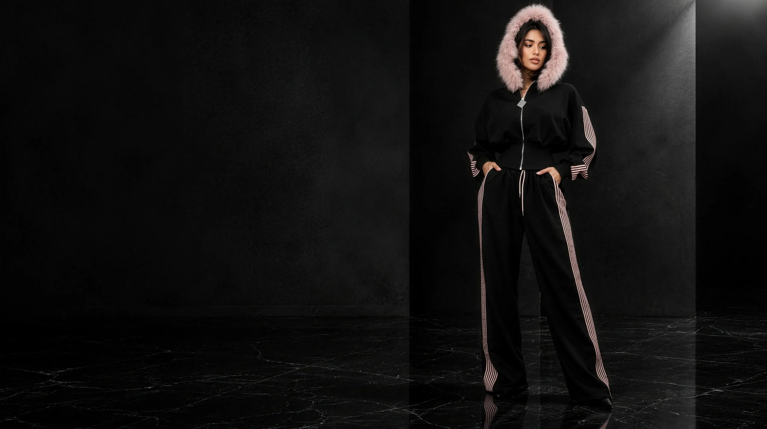 Model in the black fur-hood corset-waist tracksuit set with blush pinstripes, MIDAS Fall-Winter 26-27